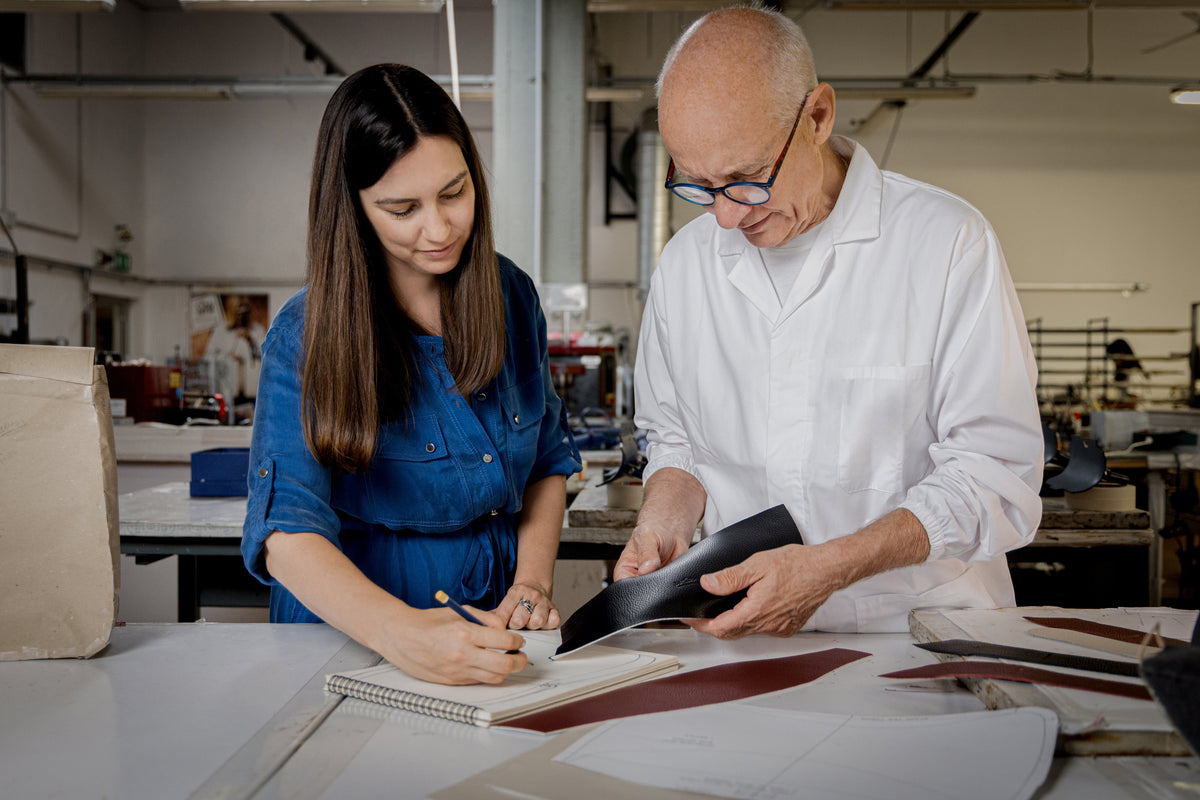Brianna Tell reviewing leatherwork with master artisan at the atelier near Florence that makes Les Tells bags